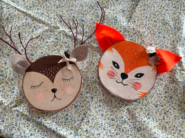 Dwie prace zrobione z plastra drewna. Po lewej znajduje się jelonek a po prawej lis.